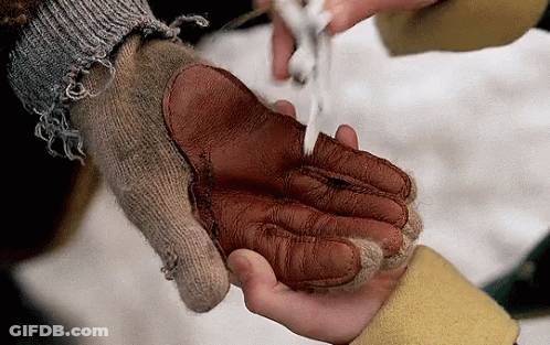 A Person Wearing A Knitted Glove Is Holding Another Person 'S Hand GIF