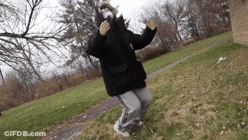 A Person Wearing A Mask And A Black Jacket Is Dancing GIF
