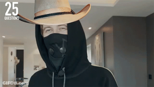 A Person Wearing A Mask And A Cowboy Hat With The Number 25 On The Bottom GIF