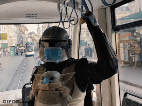 A Person Wearing A Mask And A Helmet Is Riding A Bus With A Sign That Says ' Bahnhof ' On It GIF
