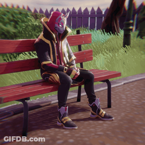 A Person Wearing A Mask Is Sitting On A Park Bench GIF