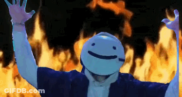 A Person Wearing A Mask With A Smiley Face Is Standing In Front Of A Fire . GIF