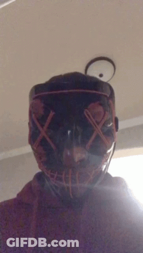 A Person Wearing A Mask With Red X 'S On The Eyes GIF