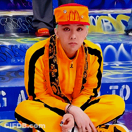 A Person Wearing A Mcdonald 'S Hat Is Sitting On A Set Of Stairs GIF