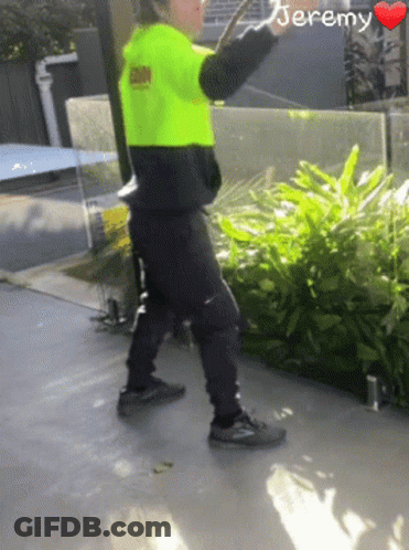 A Person Wearing A Neon Yellow Safety Vest With The Name Jeremy On It GIF