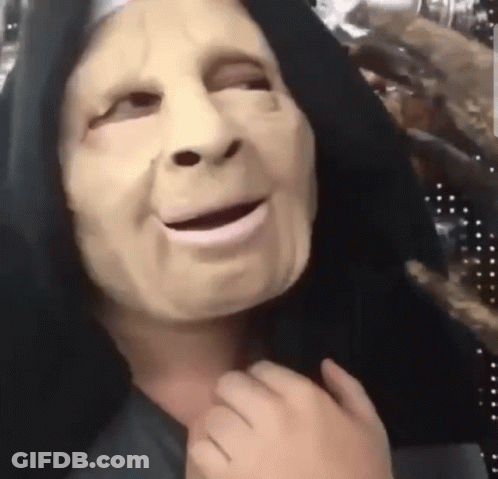 A Person Wearing A Nun Mask With A Black Hood On GIF