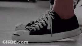 A Person Wearing A Pair Of Black And White Converse Sneakers GIF