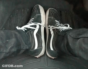 A Person Wearing A Pair Of Black And White Sneakers GIF