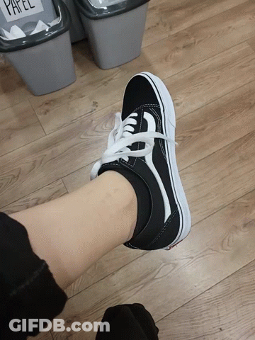 A Person Wearing A Pair Of Black And White Sneakers GIF