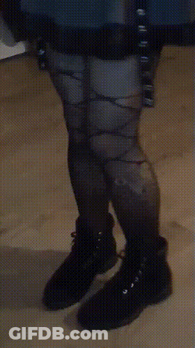 A Person Wearing A Pair Of Black Boots With A Pattern On Them GIF