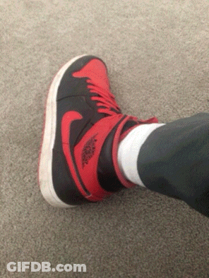 A Person Wearing A Pair Of Red And Black Air Jordans GIF