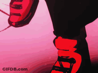 A Person Wearing A Pair Of Red And Black Shoes With The Letter A On Them GIF