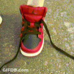 A Person Wearing A Pair Of Red And Black Sneakers GIF