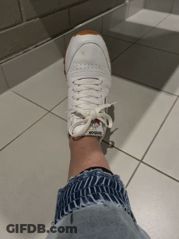 A Person Wearing A Pair Of Reebok Sneakers GIF