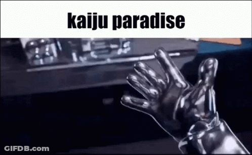 A Person Wearing A Pair Of Silver Gloves Is Waving At The Camera . GIF