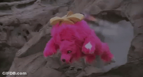 Person In Pink Costume Standing On Rocky Hill GIF