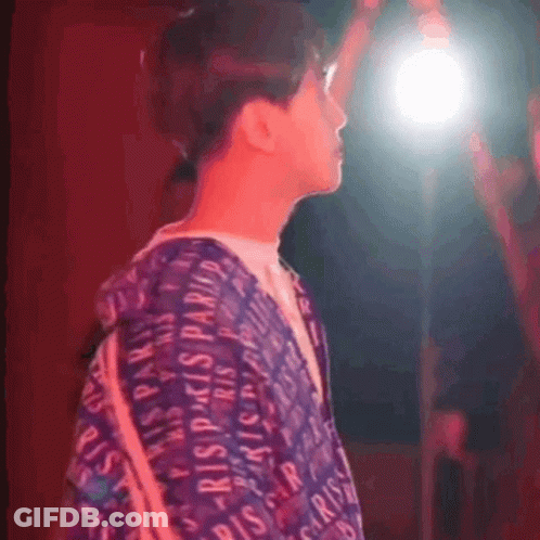 A Person Wearing A Purple Shirt That Says Paris GIF
