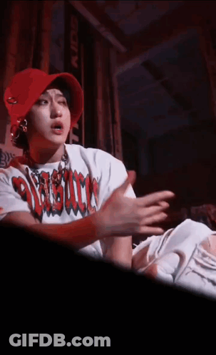 A Person Wearing A Red Hat And A White Shirt That Says ' Assault ' GIF