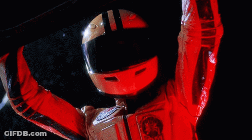 A Person Wearing A Red Helmet And A Red Jacket With A Star Wars Emblem GIF