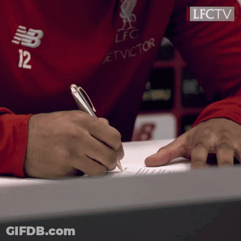 A Person Wearing A Red Shirt With The Number 12 On It Is Writing On A Piece Of Paper GIF