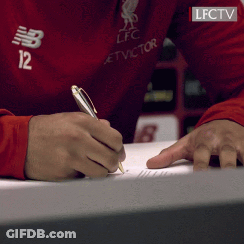 A Person Wearing A Red Shirt With The Number 12 On It Is Writing On A Piece Of Paper GIF