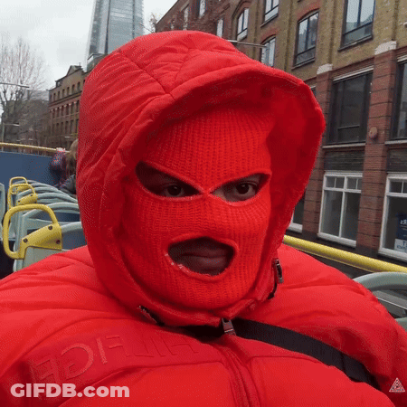 A Person Wearing A Red Ski Mask And A Red Jacket With The Word Ice On The Front GIF