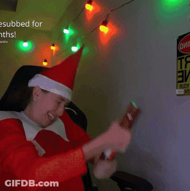 A Person Wearing A Santa Hat Is Sitting In Front Of A Sign That Says ' Esubbed For Months ' GIF
