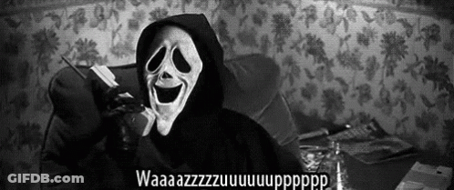 A Person Wearing A Scream Mask Is Talking On A Cell Phone . GIF
