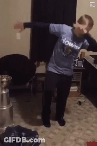 A Person Wearing A Shirt That Says Howitzer Is Dancing In A Room GIF