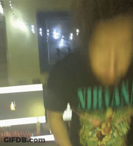 A Person Wearing A Shirt That Says Nirvana On It GIF