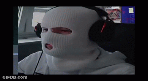A Person Wearing A Ski Mask And Headphones Looks At The Camera GIF