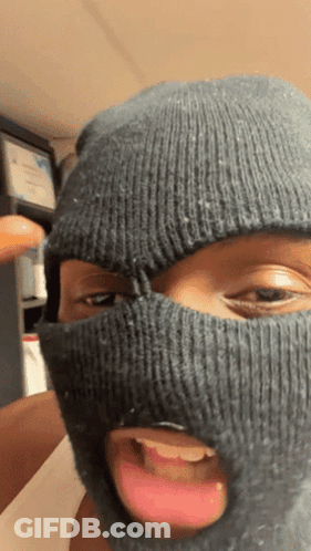 A Person Wearing A Ski Mask Is Sticking Out Their Tongue GIF