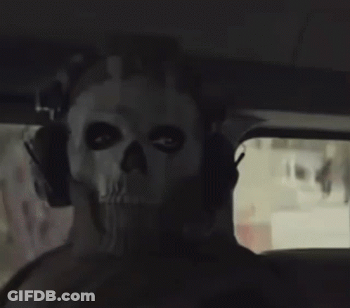 A Person Wearing A Skull Mask With Headphones On Their Head GIF