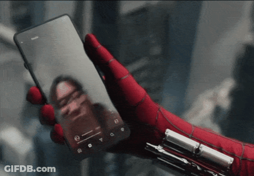 A Person Wearing A Spiderman Glove Is Holding A Phone GIF