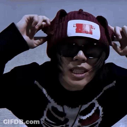A Person Wearing A Sweater With A Skeleton On It And A Beanie That Says " I Love You " On It GIF