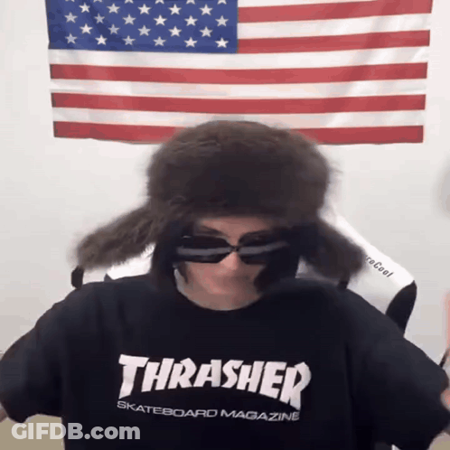 A Person Wearing A Thrasher Skateboard Magazine Shirt And Sunglasses GIF