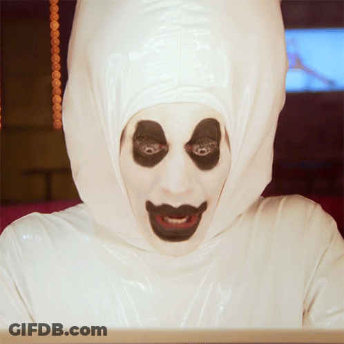 Person In White Hooded Costume With Black Eyes GIF