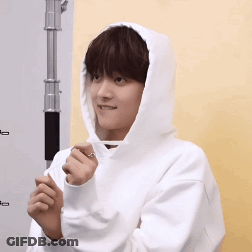 A Person Wearing A White Hoodie With A Ring On It GIF