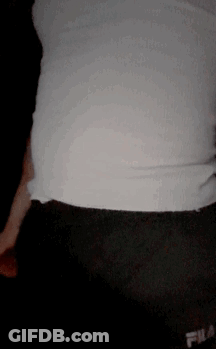 A Person Wearing A White Shirt And Black Shorts With Fila On Them GIF