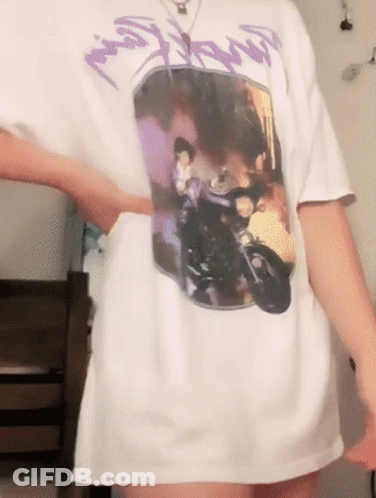 A Person Wearing A White T-Shirt With A Picture Of A Man On A Motorcycle On It GIF