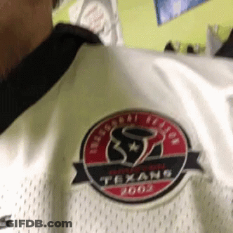 A Person Wearing A White Texans Jersey With A Red And Black Logo GIF