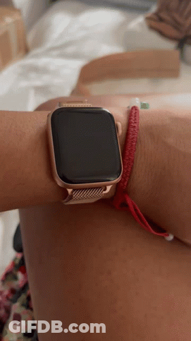 A Person Wearing An Apple Watch With A Red Bracelet On Their Wrist GIF