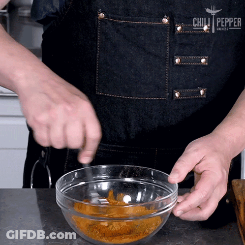 A Person Wearing An Apron That Says Chilli Pepper GIF