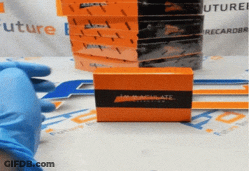 A Person Wearing Blue Gloves Is Holding An Orange Box That Says Inactivate On It GIF