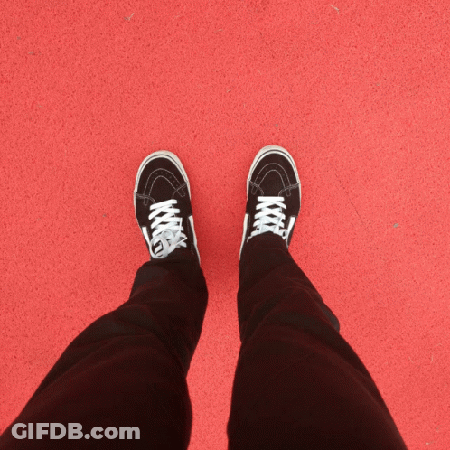 A Person Wearing Brown And White Vans Shoes Walking On A Wooden Path GIF