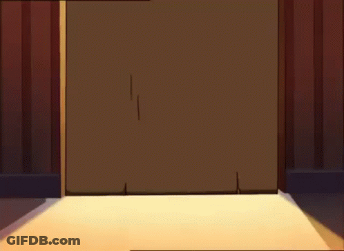 A Person Wearing Bunny Slippers Is Standing In A Doorway . GIF