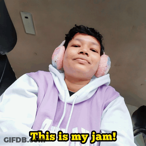 A Person Wearing Ear Muffs And A Purple Hoodie Says " This Is My Jam " GIF