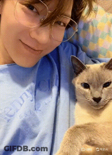A Person Wearing Glasses And A Blue Shirt That Says Chunky On It GIF