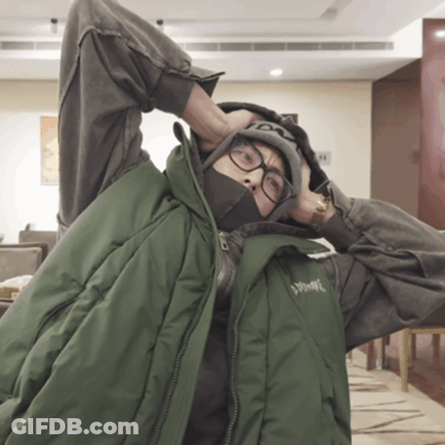 A Person Wearing Glasses And A Green Vest That Says ' Xtreme ' On It GIF