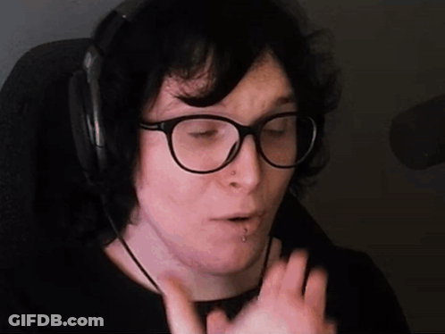 A Person Wearing Glasses And Headphones Is Making A Face GIF